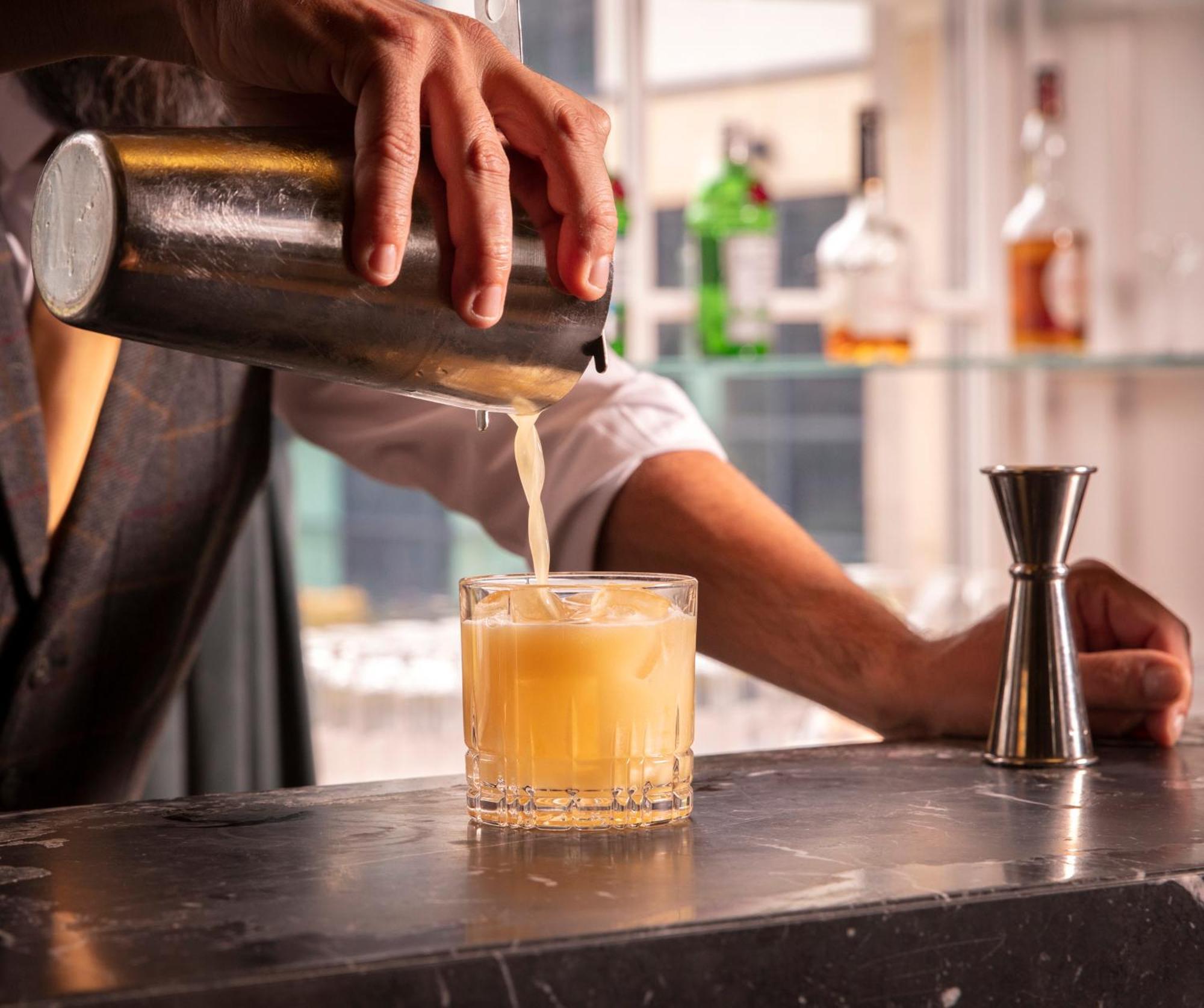 Schloss Roxburghe, Part Of Destination By Hyatt Eksteriør billede A bartender straining a cocktail